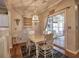 Cozy dining area with rustic table, white chairs, and decorative accents at 111 Churchcliff Dr, Woodstock, GA 30188