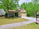 Charming one-story home with well-maintained lawn, inviting curb appeal and attached two-car garage at 111 Churchcliff Dr, Woodstock, GA 30188