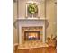 Close-up of fireplace with stone surround and decorative mantle at 111 Churchcliff Dr, Woodstock, GA 30188