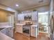 Well-lit kitchen with stainless steel appliances, white cabinets, and hardwood floors at 111 Churchcliff Dr, Woodstock, GA 30188