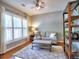 Cozy living room featuring hardwood floors, area rug, natural light and ceiling fan at 111 Churchcliff Dr, Woodstock, GA 30188