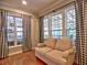 Bright living room featuring hardwood floors, neutral-toned sofa and large windows with black and white curtains at 111 Churchcliff Dr, Woodstock, GA 30188