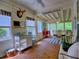 Bright sunroom with wood floors, multiple windows, and a dining area perfect for entertaining guests at 111 Churchcliff Dr, Woodstock, GA 30188
