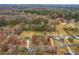 An aerial perspective shows an expansive neighborhood enveloped by lush foliage at 115 N Loblolly Xing, Temple, GA 30179