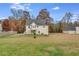 Spacious backyard showcasing a two-story home with a walkout deck, offering plenty of space at 115 N Loblolly Xing, Temple, GA 30179