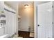 Full bathroom showing shower with curtain, toilet and shelf with amenities at 115 N Loblolly Xing, Temple, GA 30179