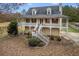 Charming home featuring a welcoming front porch, dormer windows, neatly maintained landscaping, and a spacious driveway at 115 N Loblolly Xing, Temple, GA 30179