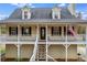 Charming home featuring a welcoming front porch, dormer windows, and neatly maintained landscaping at 115 N Loblolly Xing, Temple, GA 30179