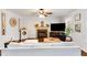 Cozy living room boasts fireplace, hardwood floors, a decorative clock, and custom white shelving at 115 N Loblolly Xing, Temple, GA 30179