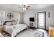 Spacious main bedroom with neutral paint, hardwood floors, crown molding, ceiling fan, and private door to outside at 115 N Loblolly Xing, Temple, GA 30179