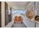 Cozy covered porch featuring a charming wooden bench and a whimsical birdhouse detail at 115 N Loblolly Xing, Temple, GA 30179