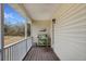 Cozy porch featuring wood floors, a quaint gardening station, and peaceful views at 115 N Loblolly Xing, Temple, GA 30179
