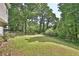 Lush green backyard with mature trees, offering shade and privacy at 4199 Wyndham Park Way, Buford, GA 30519