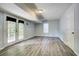 Finished basement space featuring laminate flooring and French doors leading to the outside at 4199 Wyndham Park Way, Buford, GA 30519