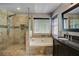 Modern bathroom featuring a glass-enclosed shower, separate tub, and granite vanity at 4199 Wyndham Park Way, Buford, GA 30519