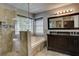Bathroom featuring a soaking tub, tiled glass shower, and dual sink vanity with granite counters at 4199 Wyndham Park Way, Buford, GA 30519