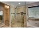 Bright bathroom showcasing a large glass shower with tile surround and built-in niche at 4199 Wyndham Park Way, Buford, GA 30519