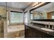 Luxurious bathroom with a soaking tub, dual vanity, and walk-in glass shower at 4199 Wyndham Park Way, Buford, GA 30519
