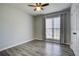 Cozy bedroom featuring neutral walls, gray laminate floors, and overhead lighting at 4199 Wyndham Park Way, Buford, GA 30519