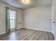Bright, empty bedroom with gray laminate floors, natural light and neutral walls at 4199 Wyndham Park Way, Buford, GA 30519