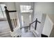 View of the home's entryway from the staircase landing with elegant chandelier at 4199 Wyndham Park Way, Buford, GA 30519