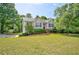 Charming home with a manicured lawn and mature trees in a suburban setting at 4199 Wyndham Park Way, Buford, GA 30519