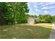 Beautifully landscaped home featuring a lush green lawn and mature trees at 4199 Wyndham Park Way, Buford, GA 30519