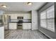 Spacious kitchen with stainless steel appliances and lots of natural light from large windows at 4199 Wyndham Park Way, Buford, GA 30519