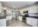 Bright kitchen featuring stainless steel appliances, granite counters, and eat-in area at 4199 Wyndham Park Way, Buford, GA 30519