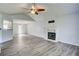 Open-concept living room featuring vaulted ceilings, fireplace, and wood grain flooring at 4199 Wyndham Park Way, Buford, GA 30519