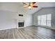 Bright living room featuring vaulted ceilings, fireplace, and wood grain flooring at 4199 Wyndham Park Way, Buford, GA 30519