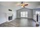 Bright living room with fireplace, vaulted ceiling, and wood grain flooring at 4199 Wyndham Park Way, Buford, GA 30519