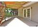 Covered patio with French doors and staircase to deck above at 4199 Wyndham Park Way, Buford, GA 30519