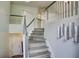 Elegant staircase featuring gray wood steps and white and gray railings at 4199 Wyndham Park Way, Buford, GA 30519