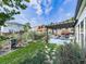 Landscaped backyard featuring a cozy patio with pergola and vibrant green lawn at 132 Neese Farm Dr, Woodstock, GA 30188
