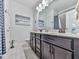 A stylish bathroom featuring double sink vanities, white tile floors and a framed mirror at 132 Neese Farm Dr, Woodstock, GA 30188