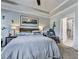 Comfortable bedroom with tray ceiling, carpeted floors, and accent decorations at 132 Neese Farm Dr, Woodstock, GA 30188