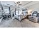 Comfortable bedroom with tray ceiling, ceiling fan, carpeted floors, desk, and accent decorations at 132 Neese Farm Dr, Woodstock, GA 30188