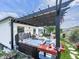 Backyard hot tub with pergola and outdoor furniture on a wooden deck at 132 Neese Farm Dr, Woodstock, GA 30188