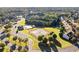 Beautiful community aerial view featuring tennis courts, pool, and clubhouse with manicured green spaces at 23 Dynasty Dr, Fairburn, GA 30213