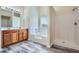 Bathroom featuring double sink vanity, soaking tub, and separate shower at 23 Dynasty Dr, Fairburn, GA 30213