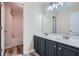 Bathroom featuring a double sink vanity, lots of mirror space, and a tub and shower combo at 23 Dynasty Dr, Fairburn, GA 30213