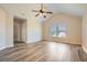 Bedroom featuring wood-look floors, ceiling fan, a doorway, and plenty of natural light at 23 Dynasty Dr, Fairburn, GA 30213