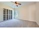 Bedroom featuring carpet floors, tall gray shelving unit, and a window to the exterior at 23 Dynasty Dr, Fairburn, GA 30213