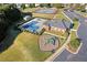 Overhead shot of the community pool, playground, and clubhouse enhance the neighborhood's appeal at 23 Dynasty Dr, Fairburn, GA 30213