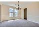 The spacious dining room boasts natural light and a stylish chandelier at 23 Dynasty Dr, Fairburn, GA 30213