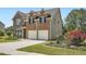 Charming two-story home with a brick facade, attached garage, and landscaped front yard at 23 Dynasty Dr, Fairburn, GA 30213
