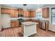 Well-equipped kitchen features granite counters, center island, and stainless steel appliances at 23 Dynasty Dr, Fairburn, GA 30213