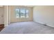 Bright living room features plush carpeting, neutral walls, and an abundance of natural light at 23 Dynasty Dr, Fairburn, GA 30213
