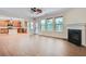 Spacious living room with a fireplace, hardwood floors, and an open layout to the kitchen at 23 Dynasty Dr, Fairburn, GA 30213